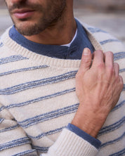 Model wearing a fuzzy striped crew sweater in cream and blue, showcasing casual elegance and vintage-inspired style.