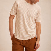 Striped Stretch Crewneck T-Shirt in Tan worn by a model, showcasing its soft fabric and stylish stripe design.