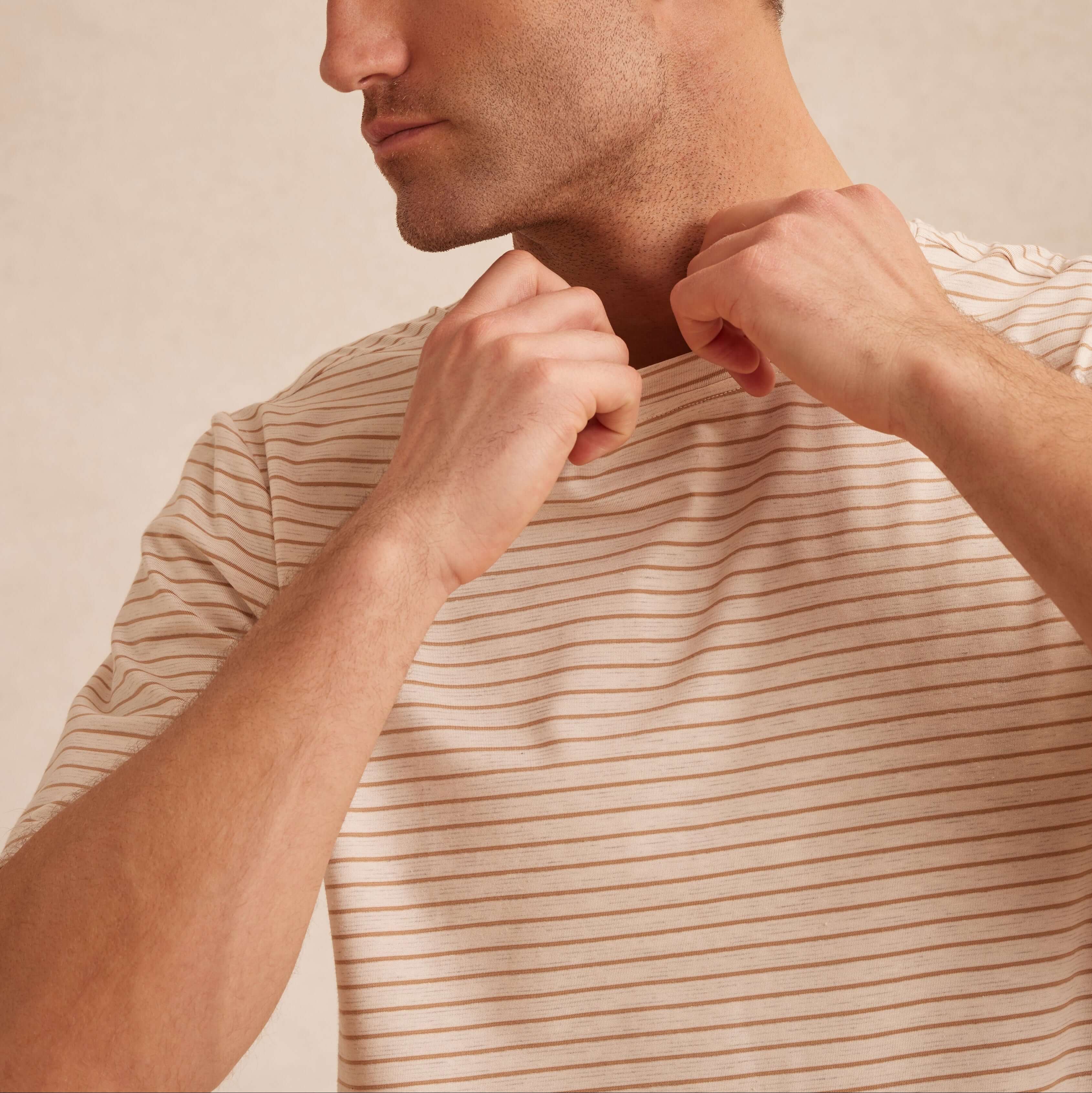 Striped Stretch Crewneck T-Shirt in Tan model adjusting shirt collar