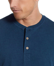 Close-up of a man wearing a Short Sleeve Henley in Deep Cobalt, showcasing the rib-knit neck and button placket.