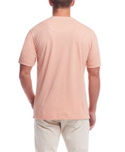 Back view of a model wearing a Short Sleeve Melange Henley In Dusty Pink, showcasing the classic design.