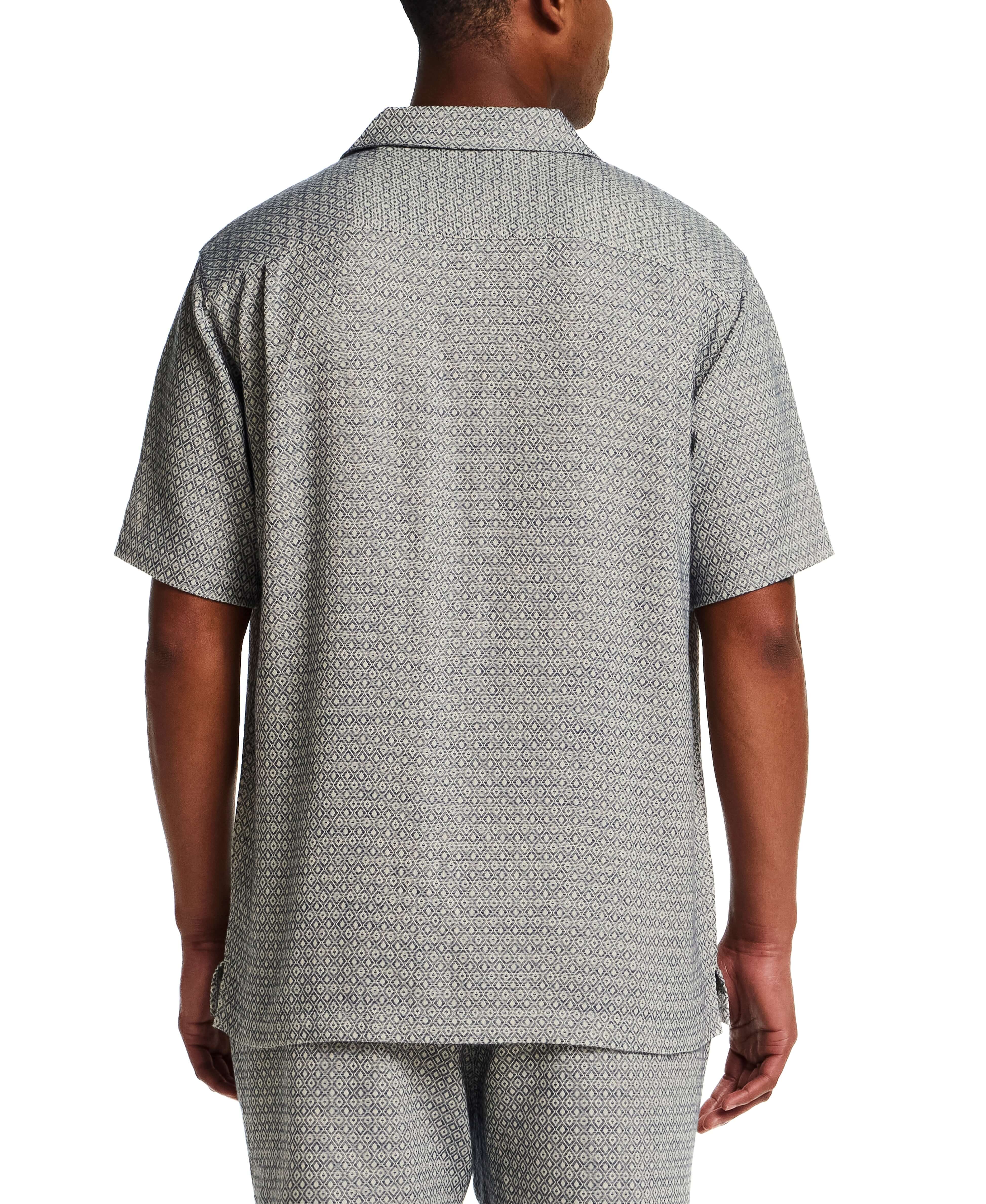 Back view of a man wearing a Jacquard Resort Shirt in Navy Diamond, showcasing the textured fabric and resort collar.