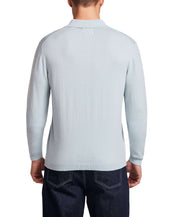 Back view of a model wearing a Cotton Cashmere Long Sleeve Polo in Aqua, showcasing its lightweight knit design.