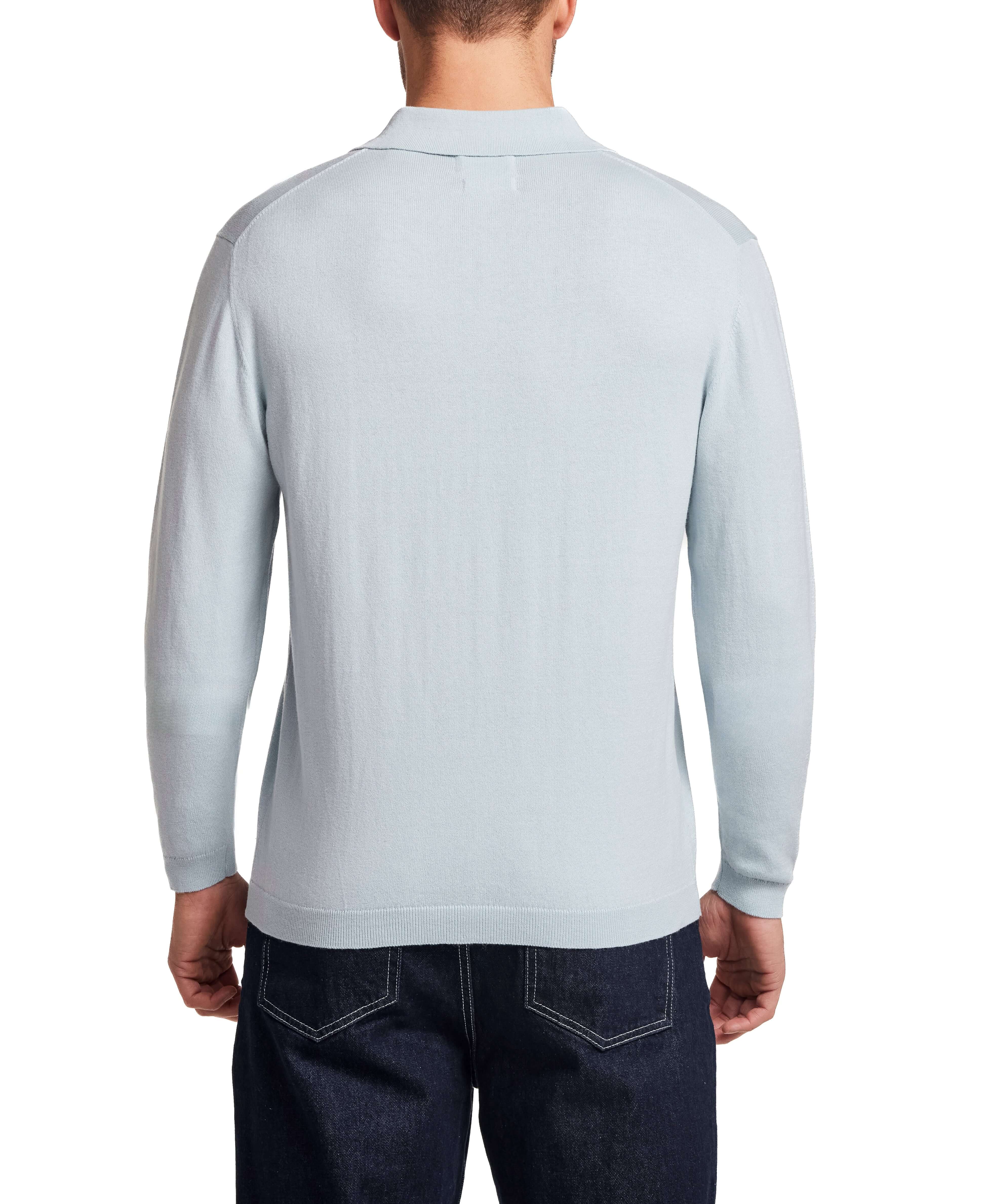 Back view of a model wearing a Cotton Cashmere Long Sleeve Polo in Aqua, showcasing its lightweight knit design.