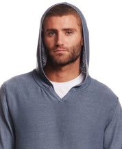 STONE WASH HOODED SWEATER W POCKET in ENSIGN BLUE worn by a model with a serious expression.