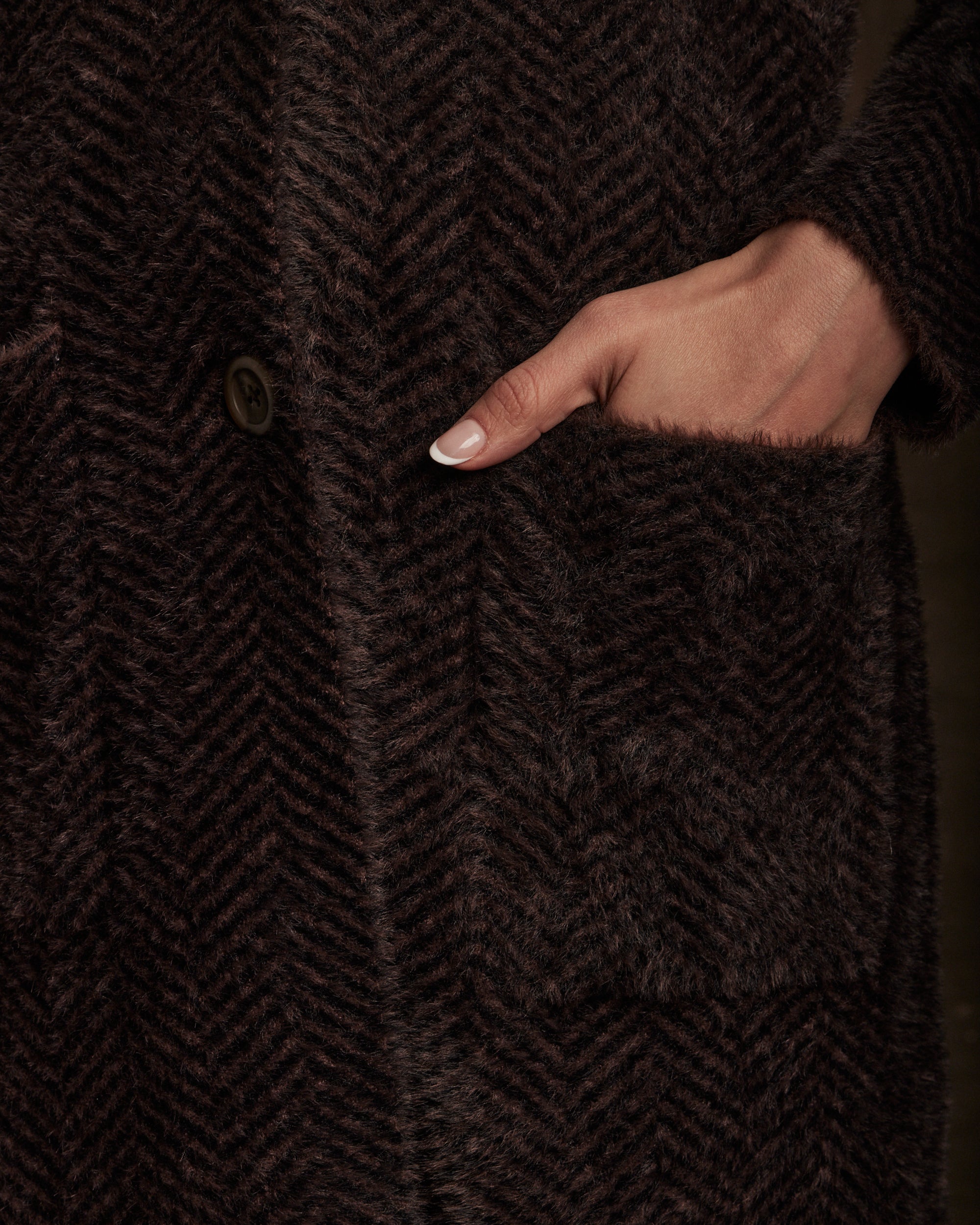 Close-up of Women's Plush Herringbone Coatigan in Chocolate showing herringbone pattern and patch pocket.