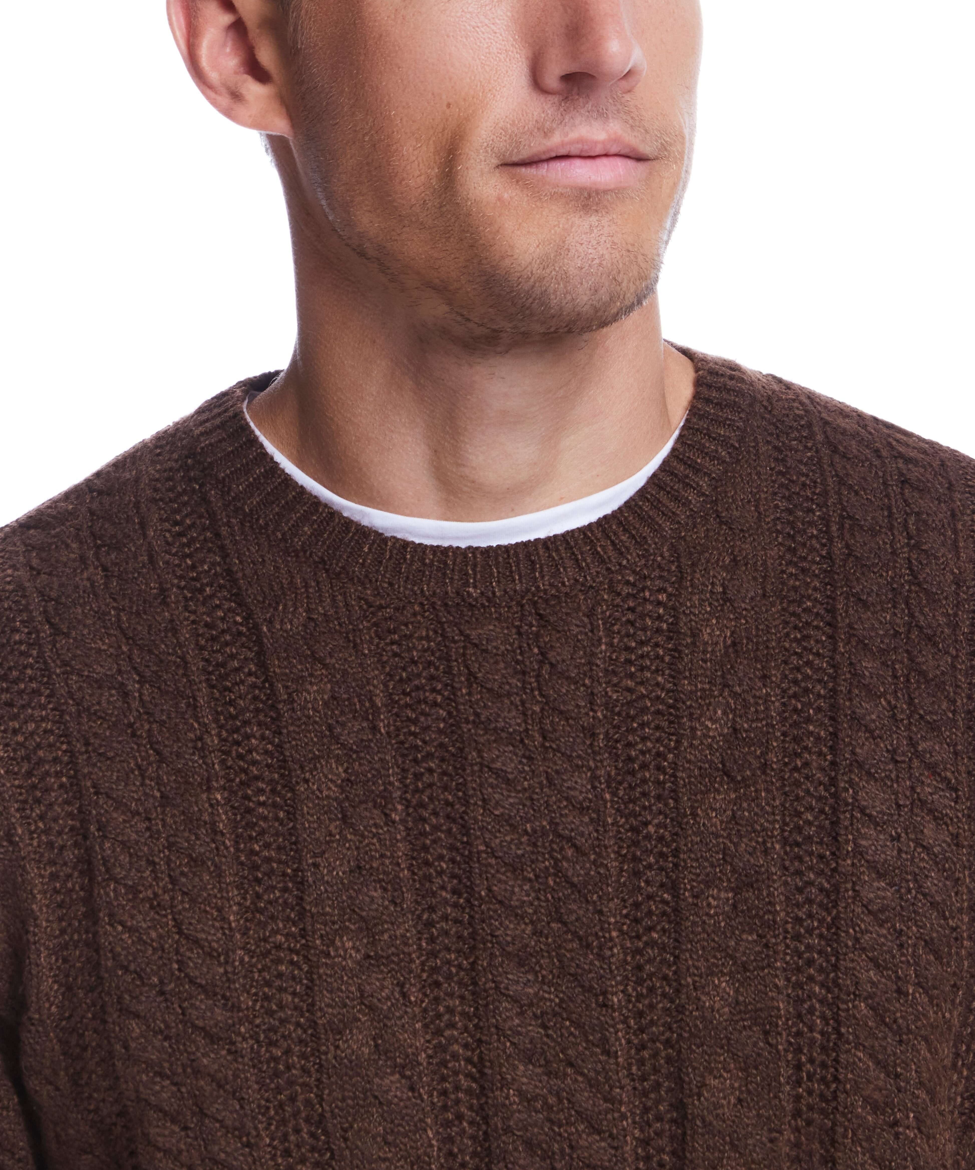 Man wearing a chicory allover cable crew sweater, showcasing a classic mid-layer knit design for cooler weather.