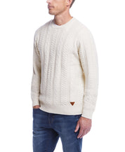 Model wearing Allover Cable Crew sweater in Whitecap, ideal mid-layer for cooler weather, featuring classic cable knit design.
