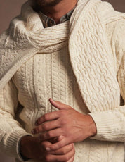 Model wearing an allover cable knit sweater in Whitecap, perfect for cooler weather and everyday style.