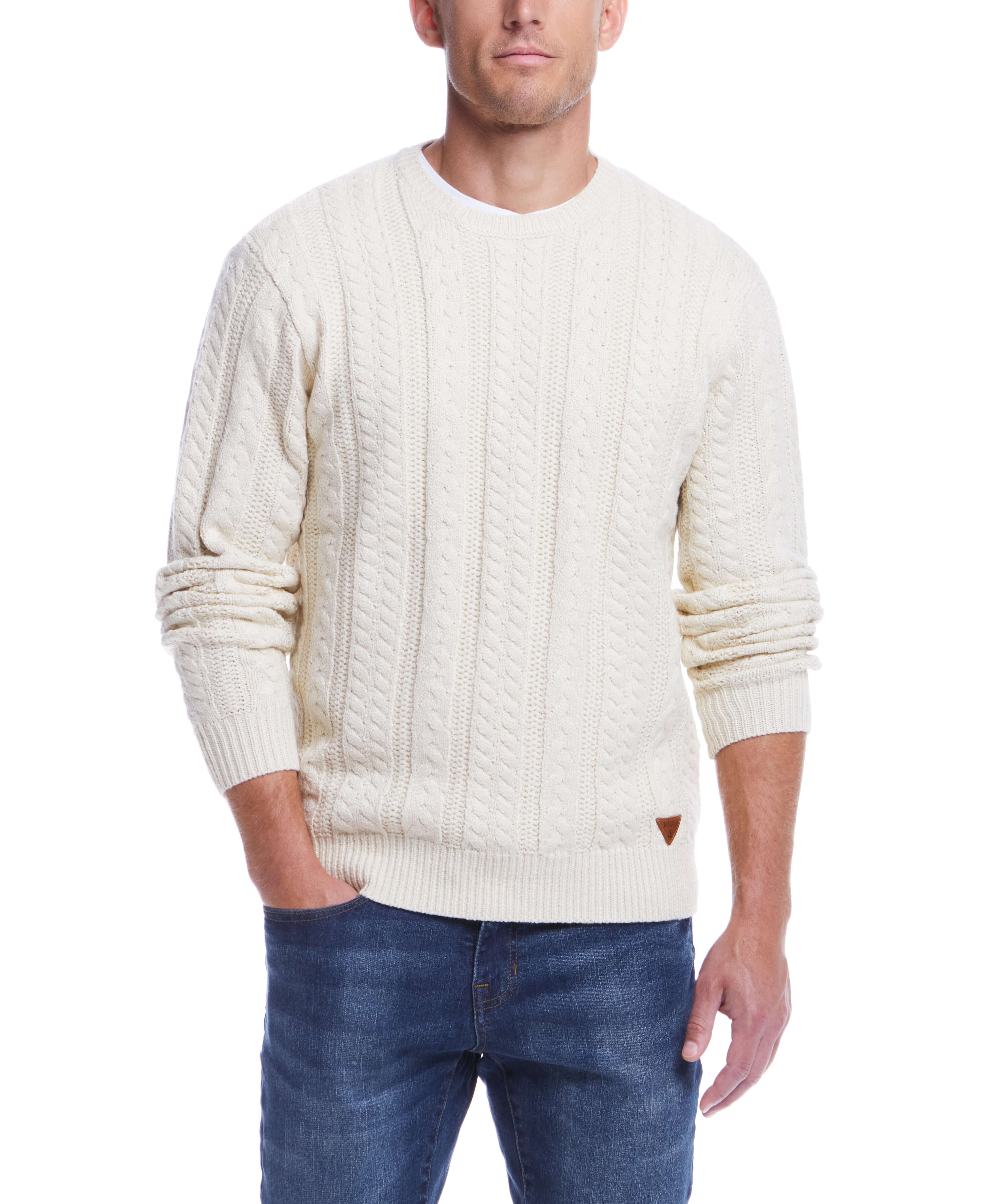 Model wearing an allover cable knit crew sweater in Whitecap, perfect for cooler weather.