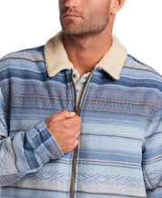 Close-up of a man wearing a Berber Lined Southwest Rancher Jacket in Dusty Blue with a soft sherpa collar.