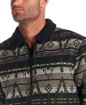 Close-up of a man wearing the Berber Lined Southwest Rancher Jacket in Olive Black with a sherpa collar.