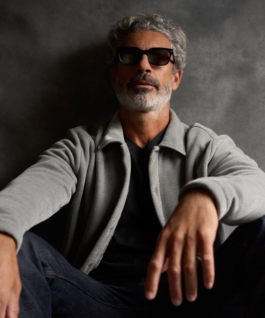 Man wearing a Brushed Corded Shirt Jacket in Ultimate Grey, sitting casually against a grey background.