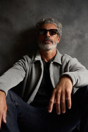 Man wearing a Brushed Corded Shirt Jacket in Ultimate Grey, sitting casually against a grey background.