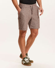 Chambray Stripe Drawstring Short in Brown Stripe displayed on a model, featuring lightweight linen-cotton fabric and side pockets.