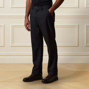 Check Pants in Black/Charcoal showcased on model, featuring a refined checkered texture and classic tailored fit.