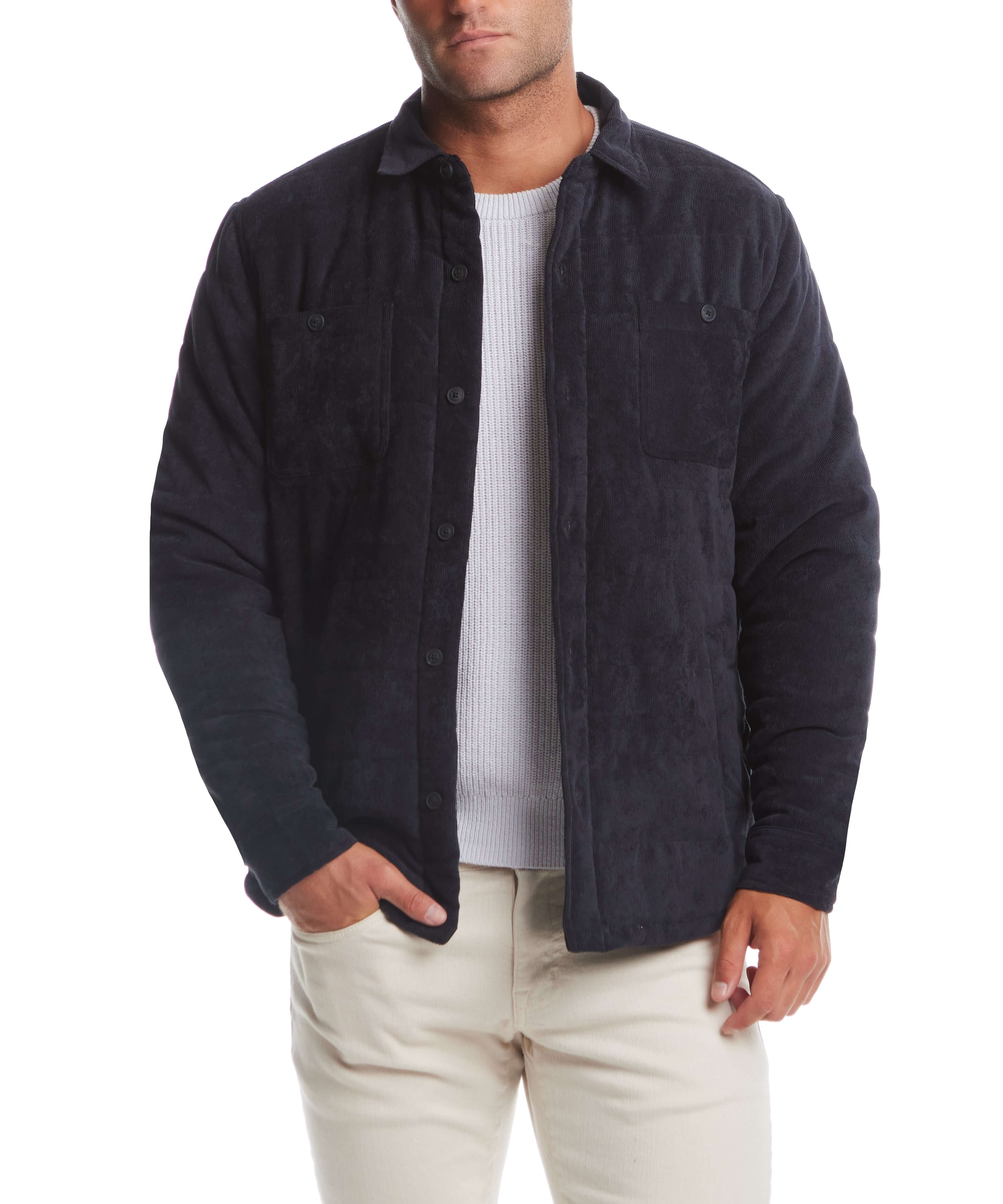 Man wearing a corded puffer jacket in moonless night, featuring button front and breast pockets, perfect for winter style.