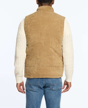 Back view of a man wearing a corded puffer vest in kangaroo color, featuring sherpa lining and side pockets.