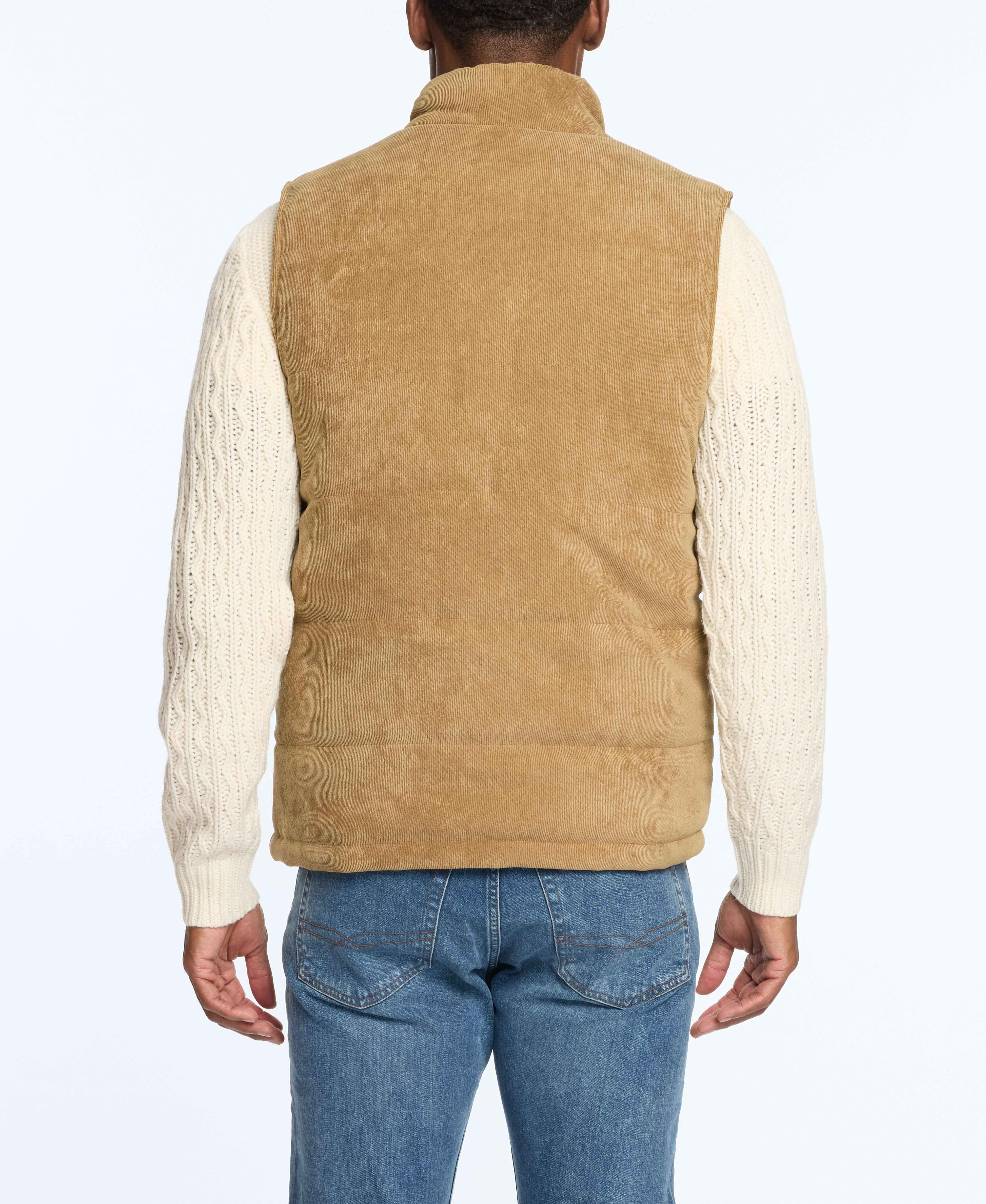 Back view of a man wearing a corded puffer vest in kangaroo color, featuring sherpa lining and side pockets.