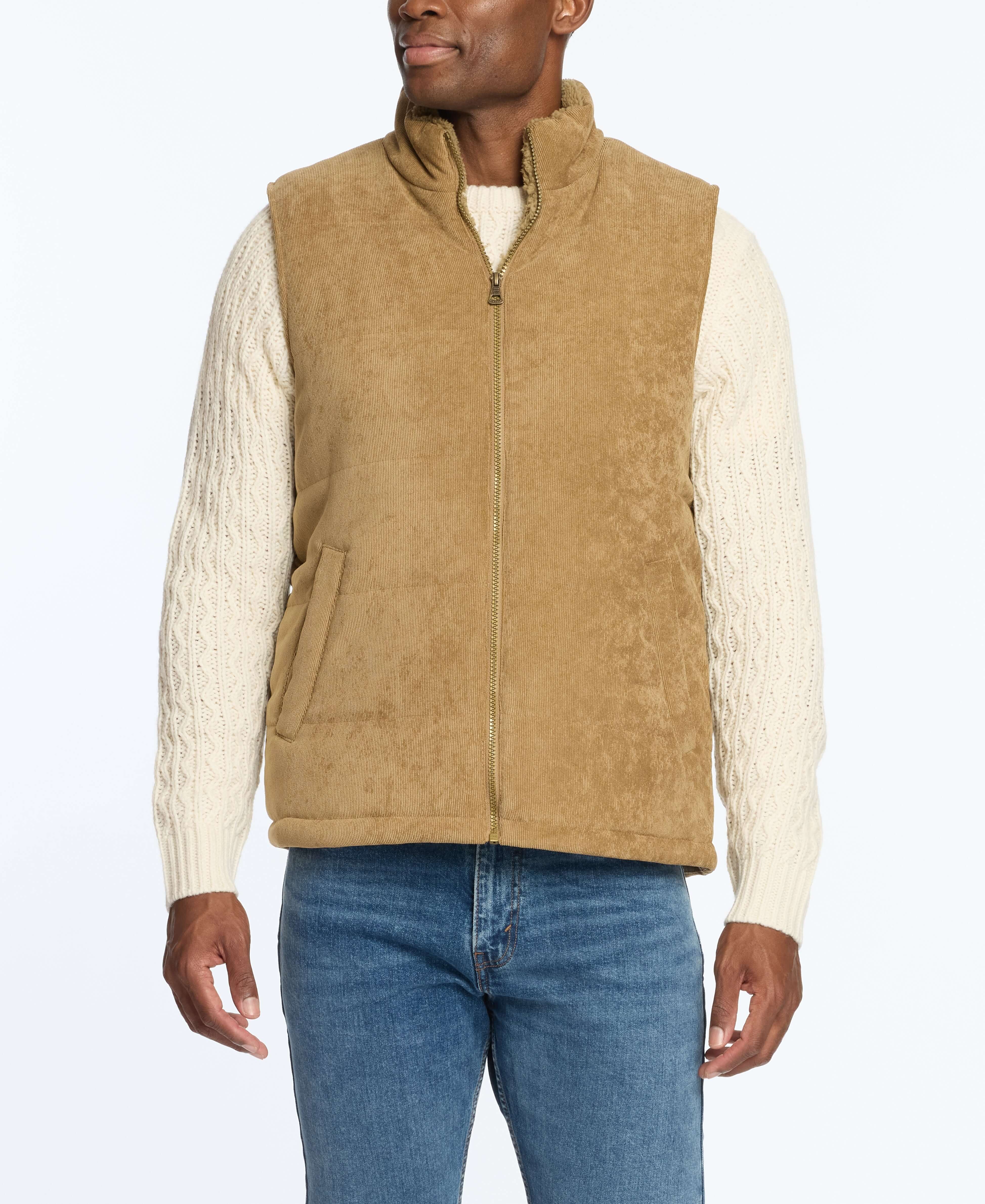 Corded puffer vest in kangaroo color featuring shearling lining, worn over a cream sweater and blue jeans.