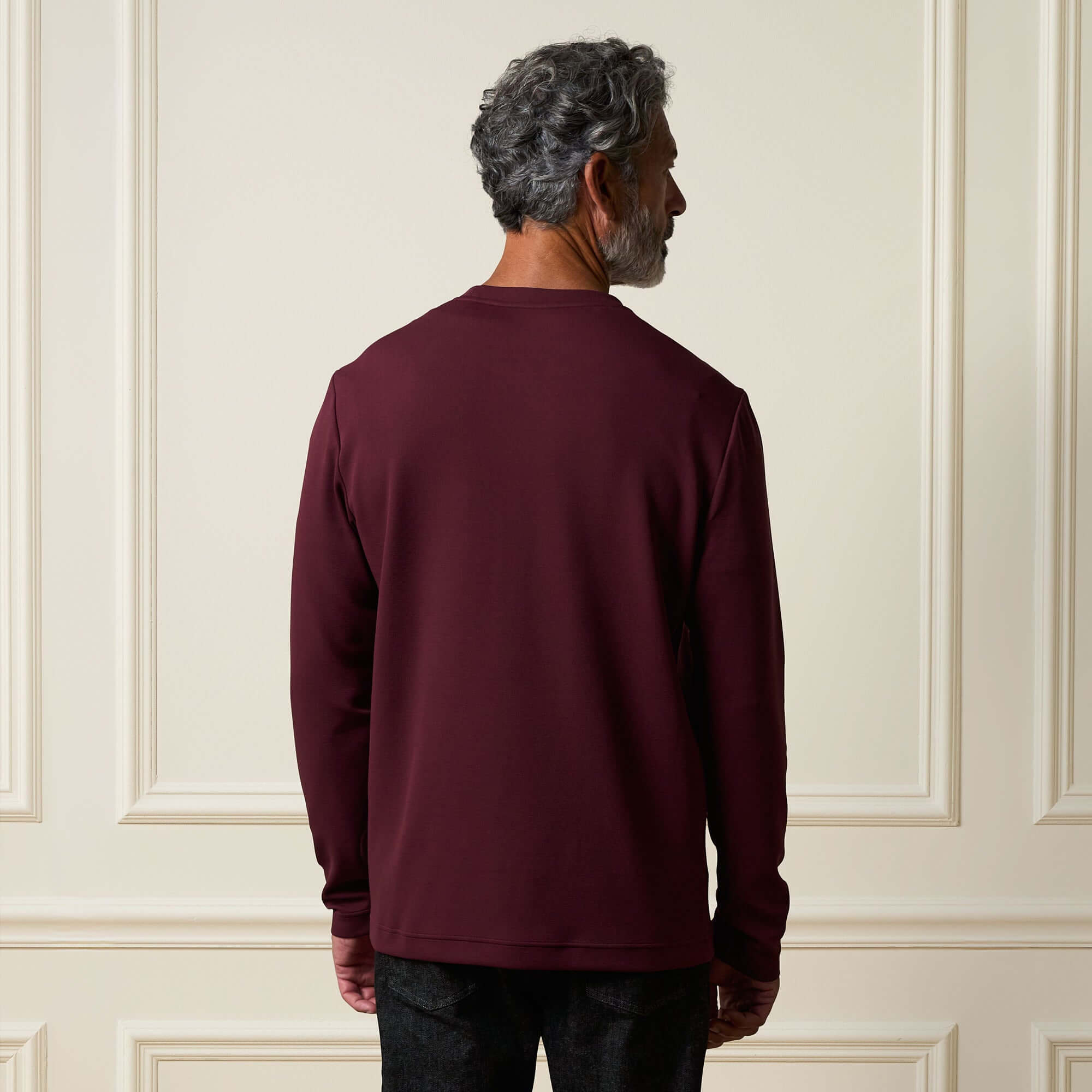 Back view of a man wearing the Crinkle Scuba Crew Neck in Burgundy, showcasing its relaxed fit and soft texture.