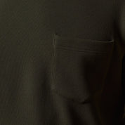 Close-up of the Crinkle Scuba Crew Neck in Olive showcasing the pocket detail and textured fabric.