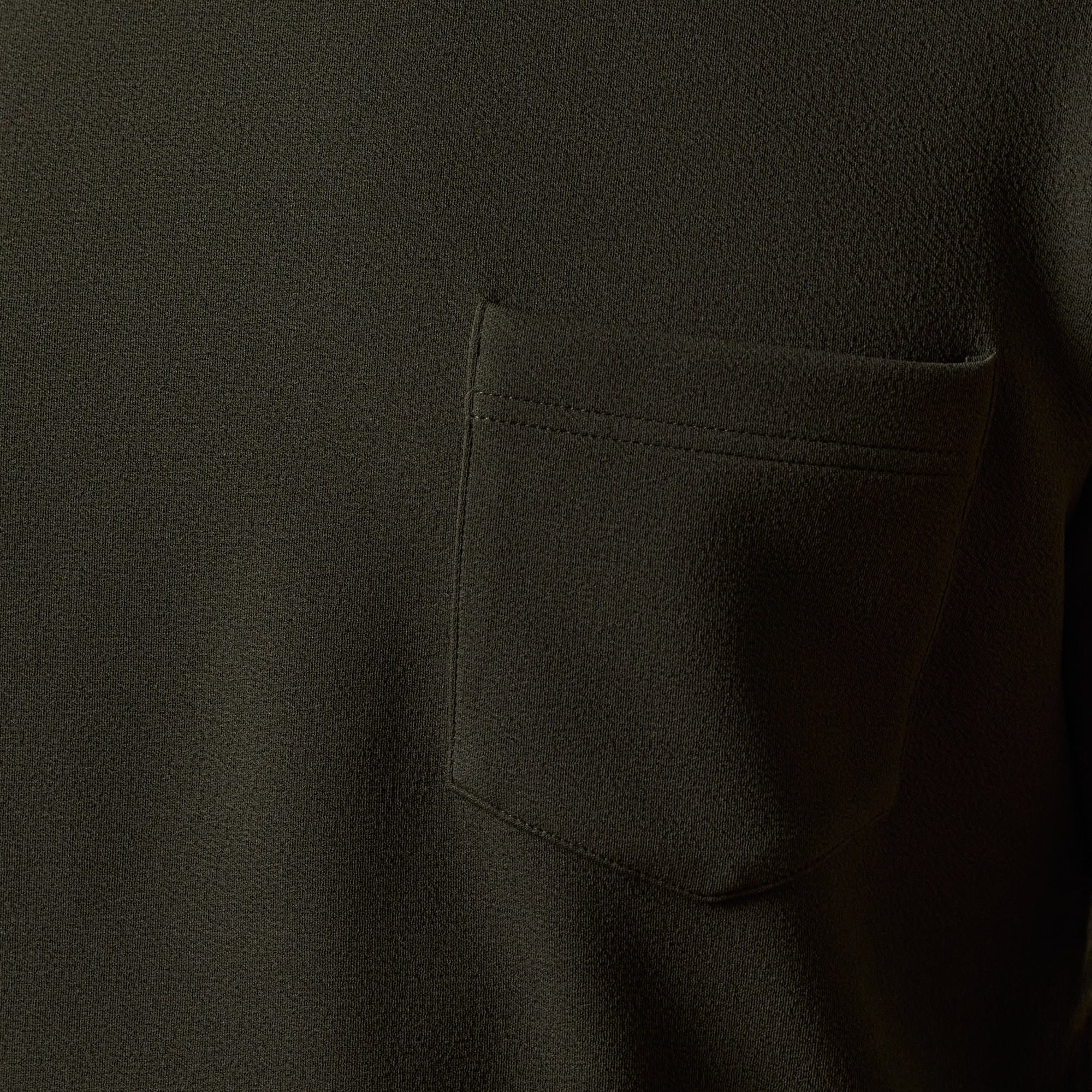 Close-up of the Crinkle Scuba Crew Neck in Olive showcasing the pocket detail and textured fabric.