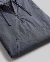 Distressed Poplin Hooded Pullover in Indigo laid flat, showcasing its half-zip front and front pouch pocket.
