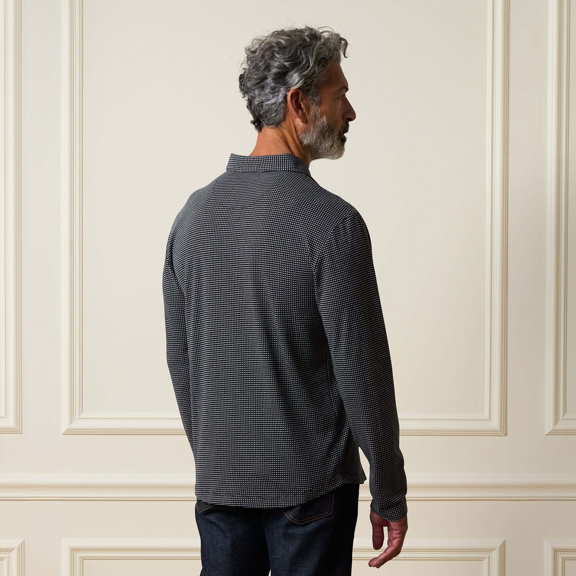 Dobby Button Down Shirt in Black worn by a man showing the back view and subtle texture.