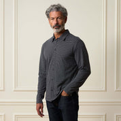 Dobby Button Down Shirt in Black worn by a man, showcasing its versatile style and subtle texture.