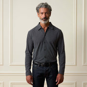 Dobby Button Down Shirt in Black worn by a man, featuring a button front, spread collar, and long sleeves.