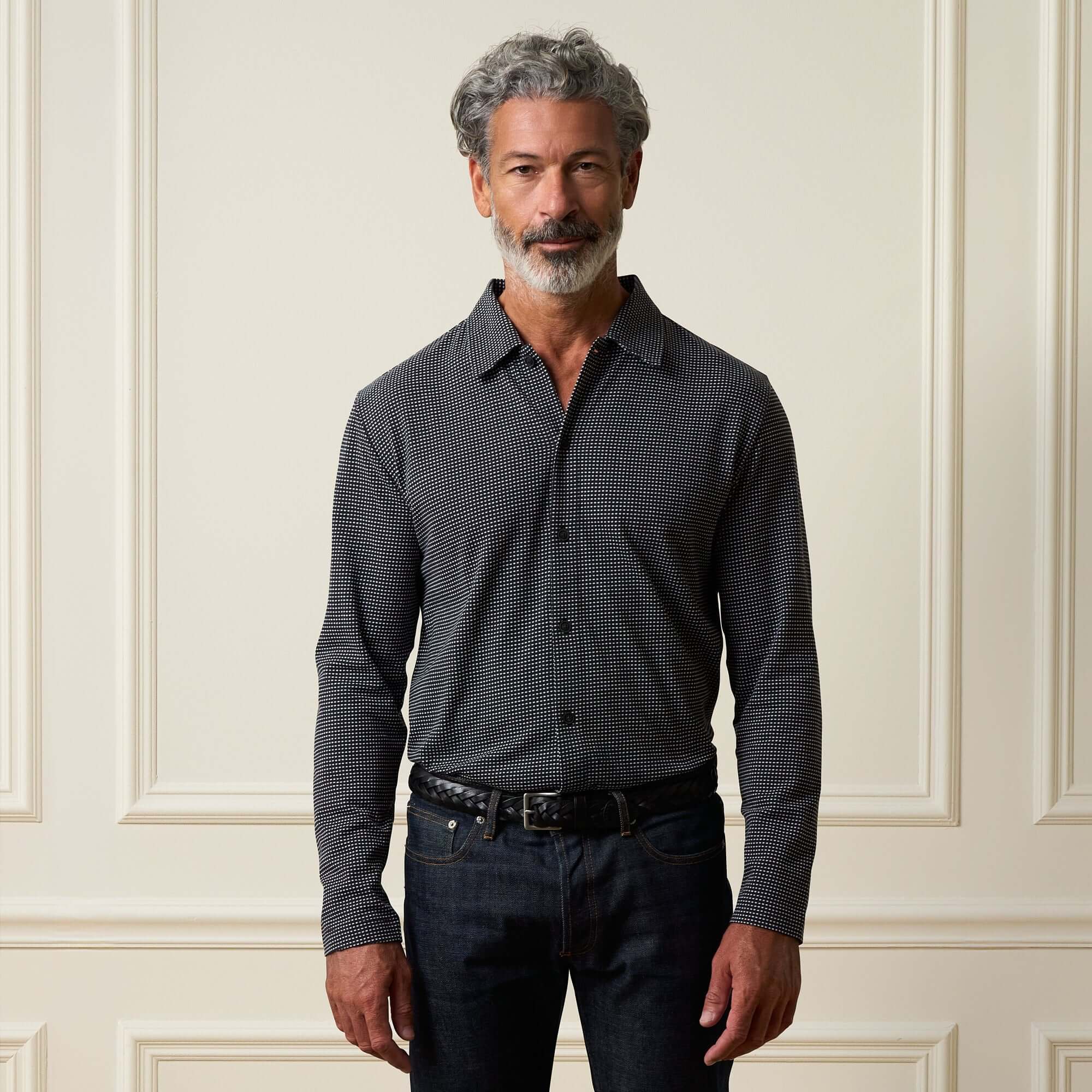 Dobby Button Down Shirt in Black worn by a man, featuring a button front, spread collar, and long sleeves.