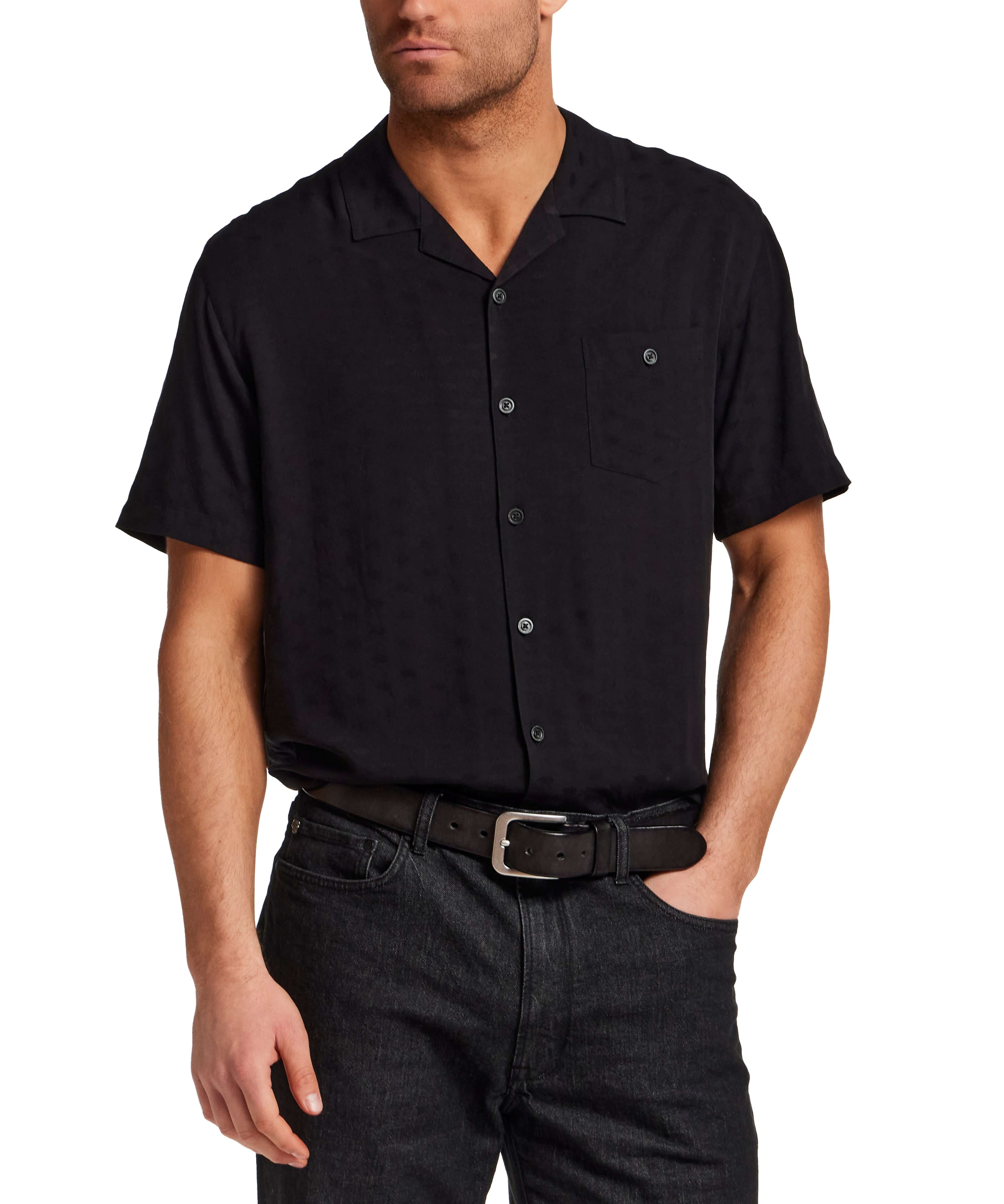 The Dobby Camp Collar Shirt in Black modeled by a man, showcasing the relaxed fit and camp collar design.