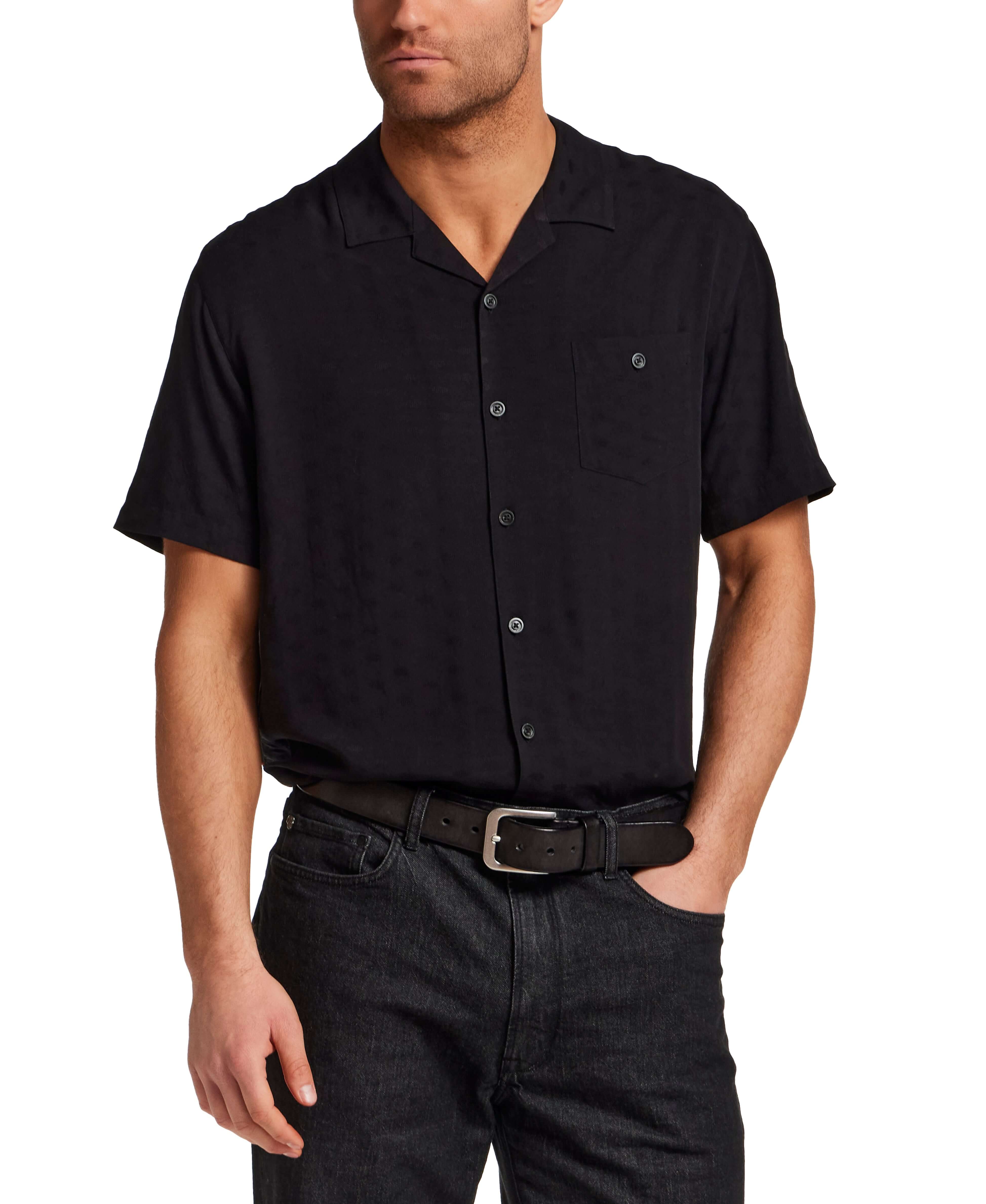 The Dobby Camp Collar Shirt in Black modeled by a man, showcasing the relaxed fit and camp collar design.