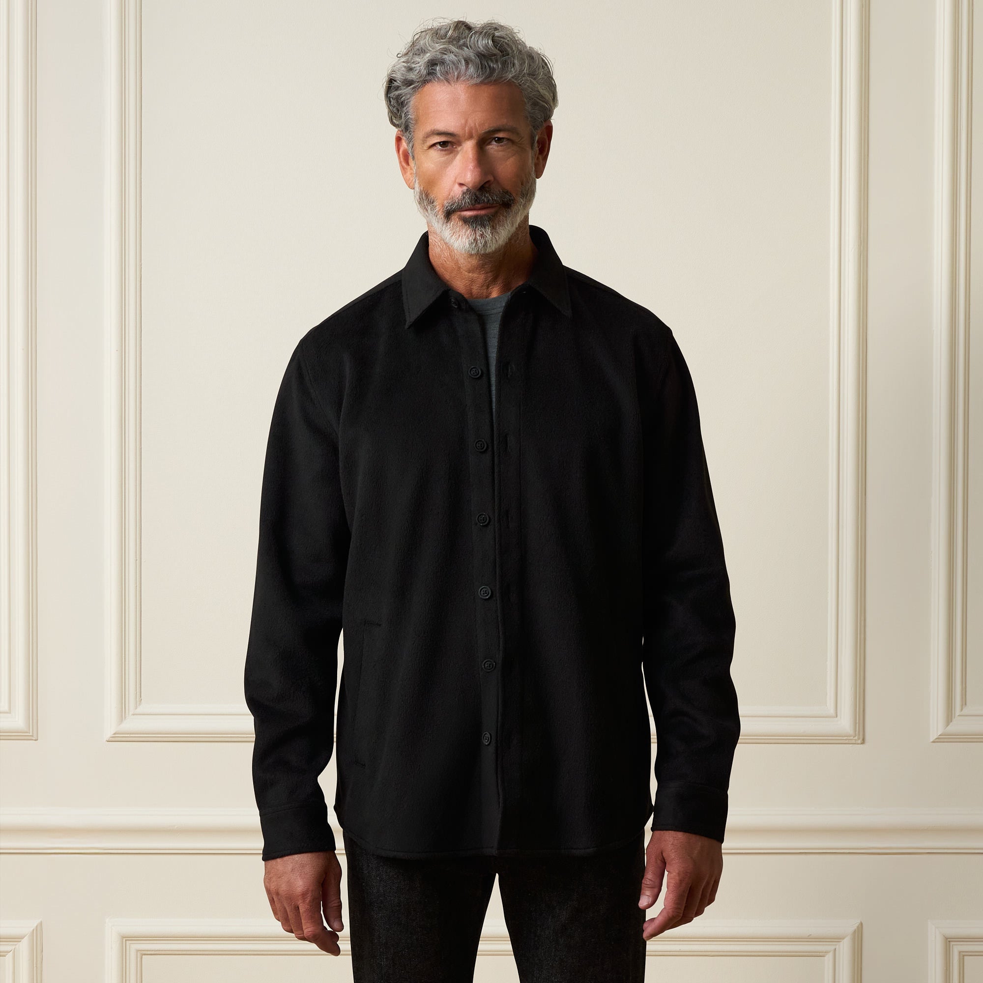 Faux Wool Shirt Jacket in Black worn by a model featuring a button-up design and a classic spread collar.