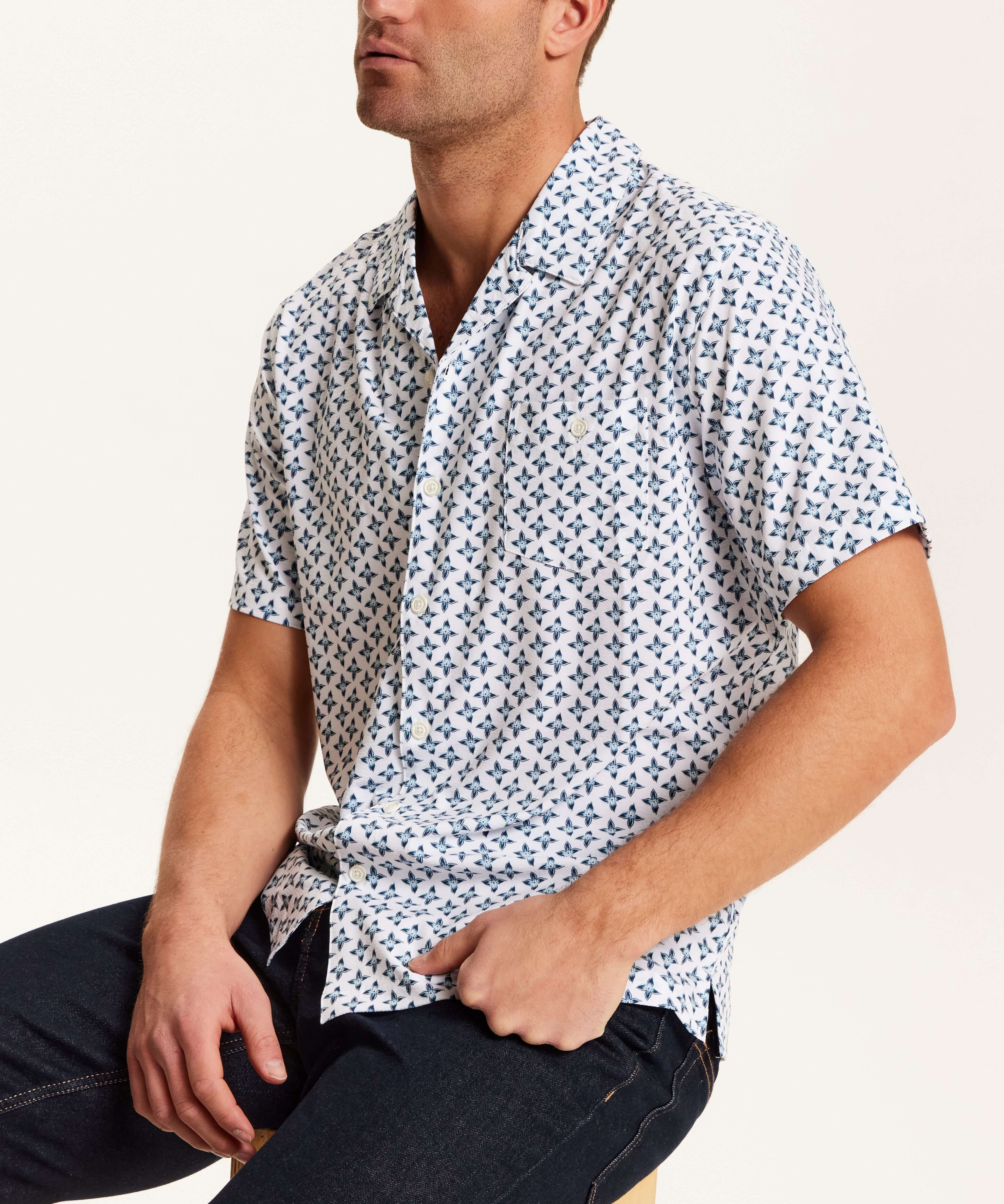 Floral Seersucker Shirt in White worn by a man, featuring a navy floral medallion print and camp collar.