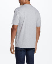 Back view of a man wearing a Graphic Tee In Grey Heather, showcasing the relaxed fit and soft fabric.