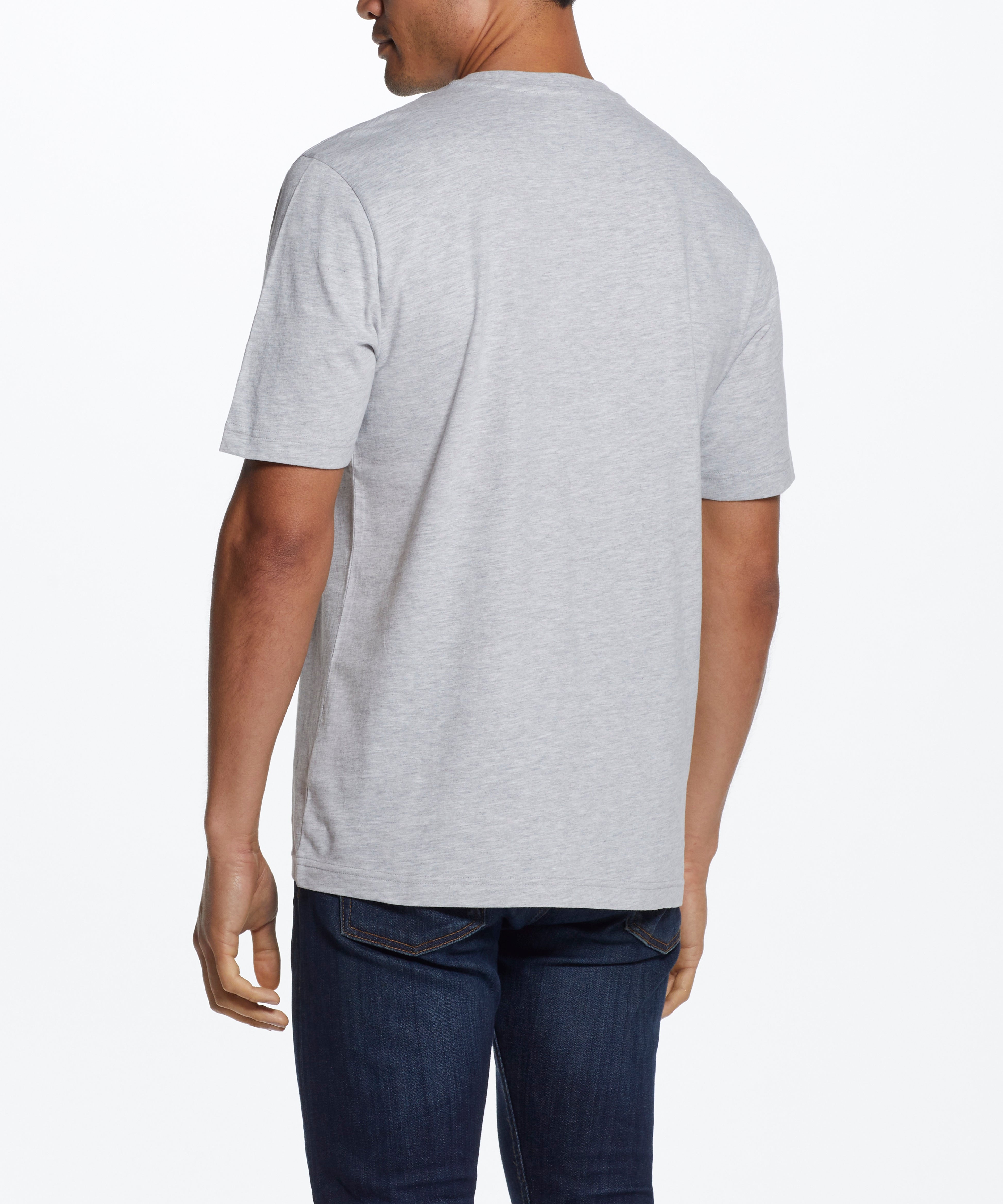 Back view of a man wearing a Graphic Tee In Grey Heather, showcasing the relaxed fit and soft fabric.