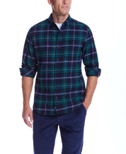 Model wearing Holiday Antique Flannel in Verdant Green, featuring a button down collar and a stylish plaid design.