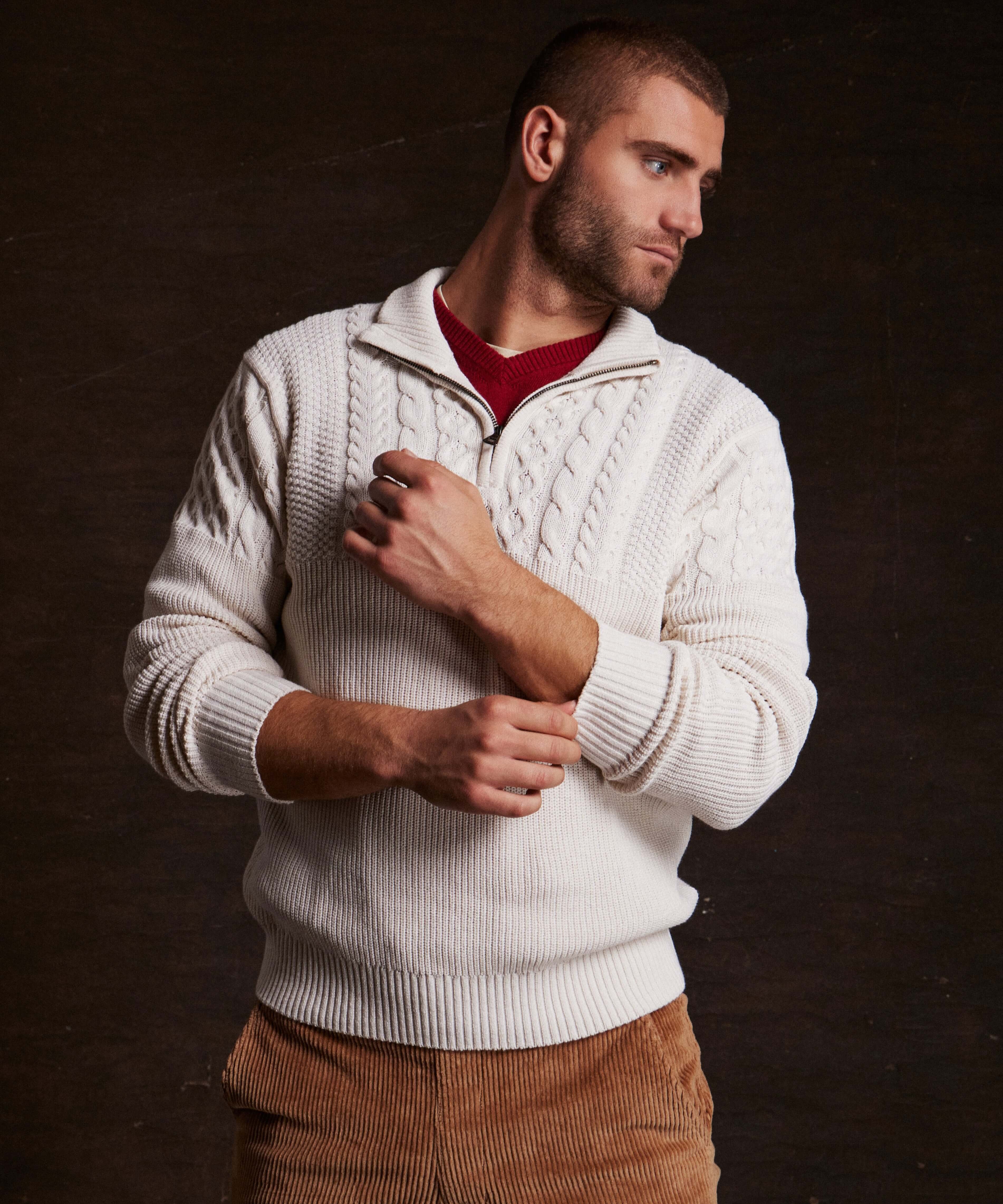 Man wearing an Ecru Holiday Cable Yoke Quarter Zip Sweater, styled for cozy casual living.