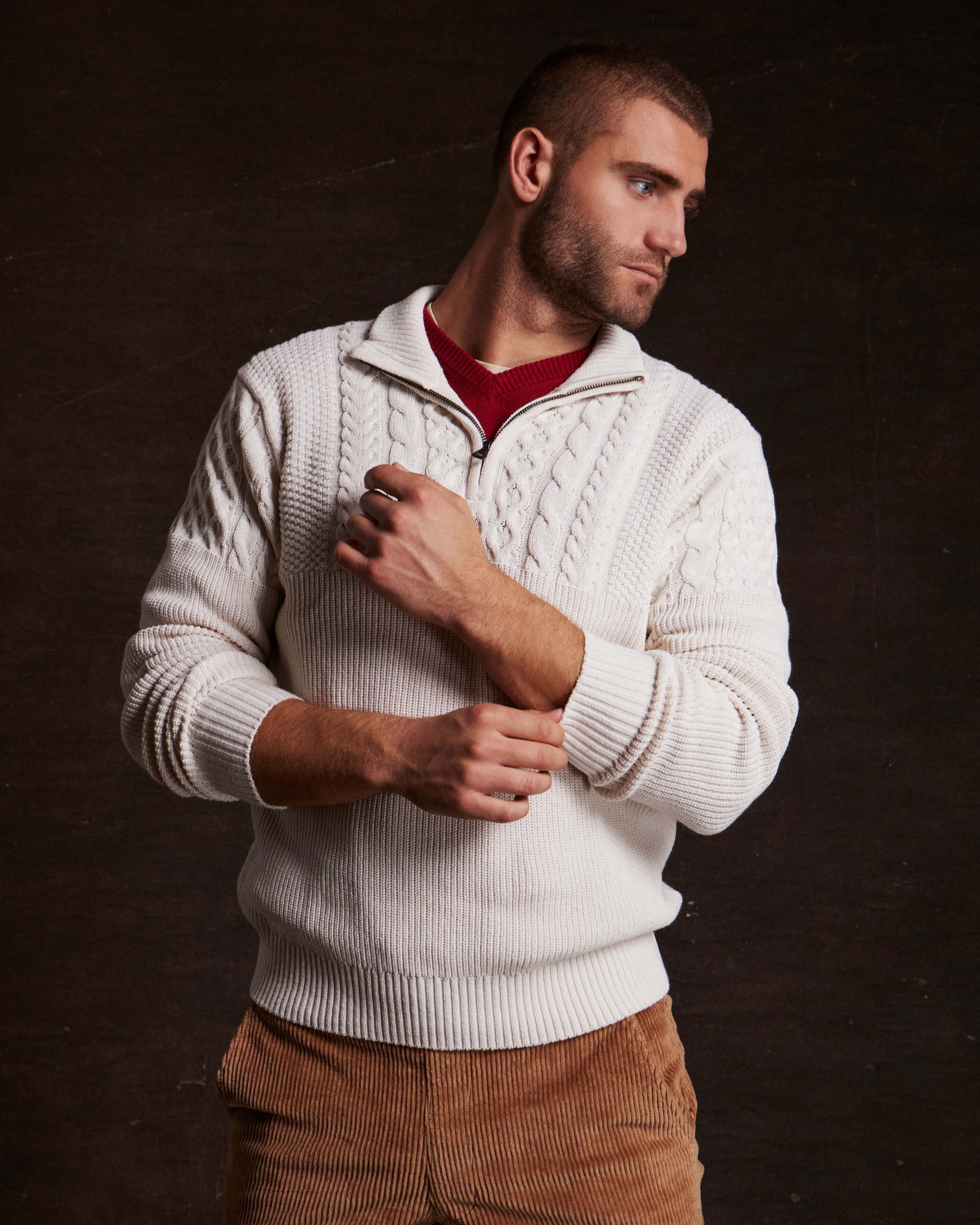 Man wearing an Ecru Holiday Cable Yoke Quarter Zip Sweater, styled for cozy casual living.