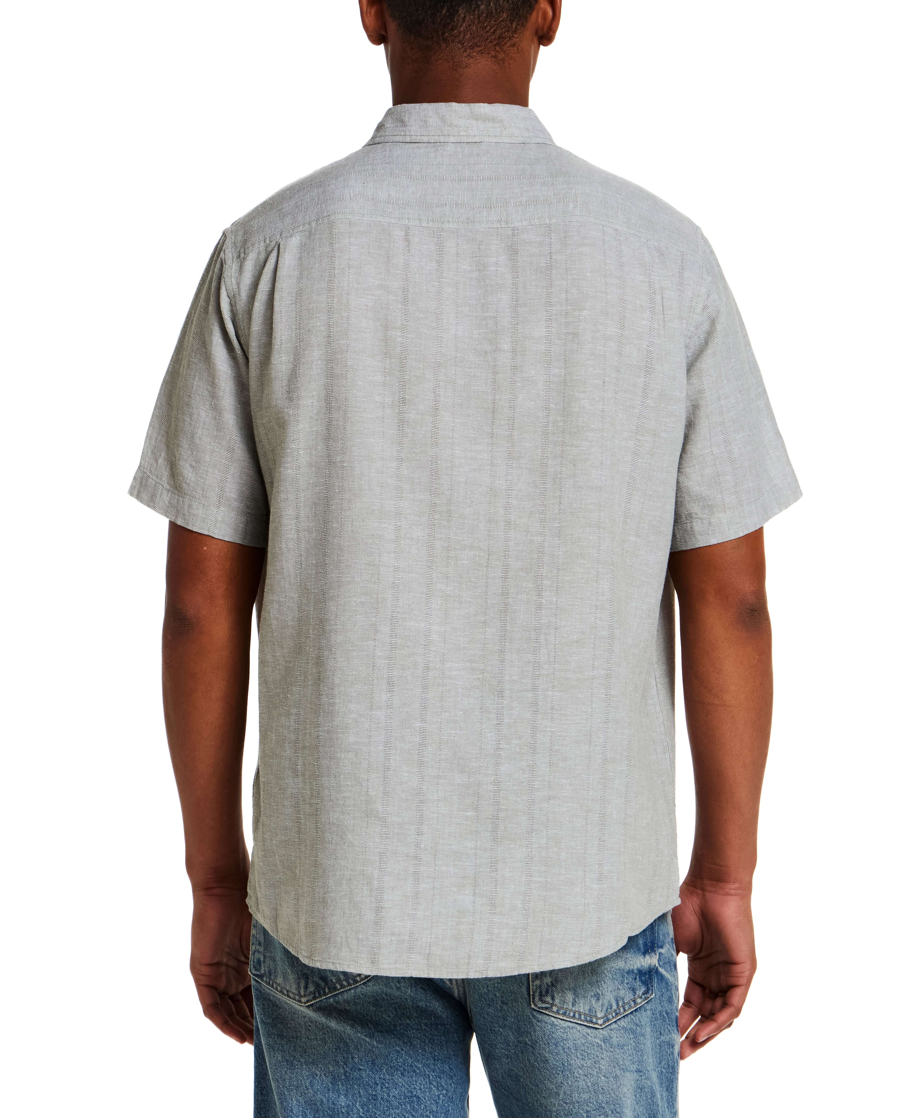 Back view of a model wearing a Linen Blend Dobby Stripe Shirt in Sea Grass, showcasing the short sleeves and subtle texture.