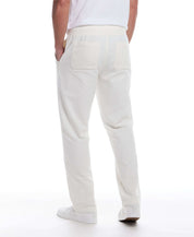 Back view of white linen blend drawstring pants featuring elastic waist and side pockets.