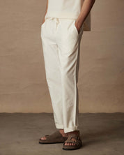 Linen blend drawstring pants in white, featuring a relaxed fit, elastic waistband, and side pockets, perfect for casual wear.