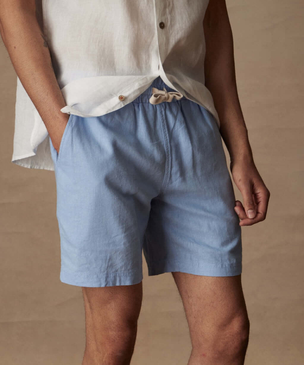 Breezy 7" linen shorts in fjord blue with elastic waist and adjustable drawcord, styled with a casual shirt.