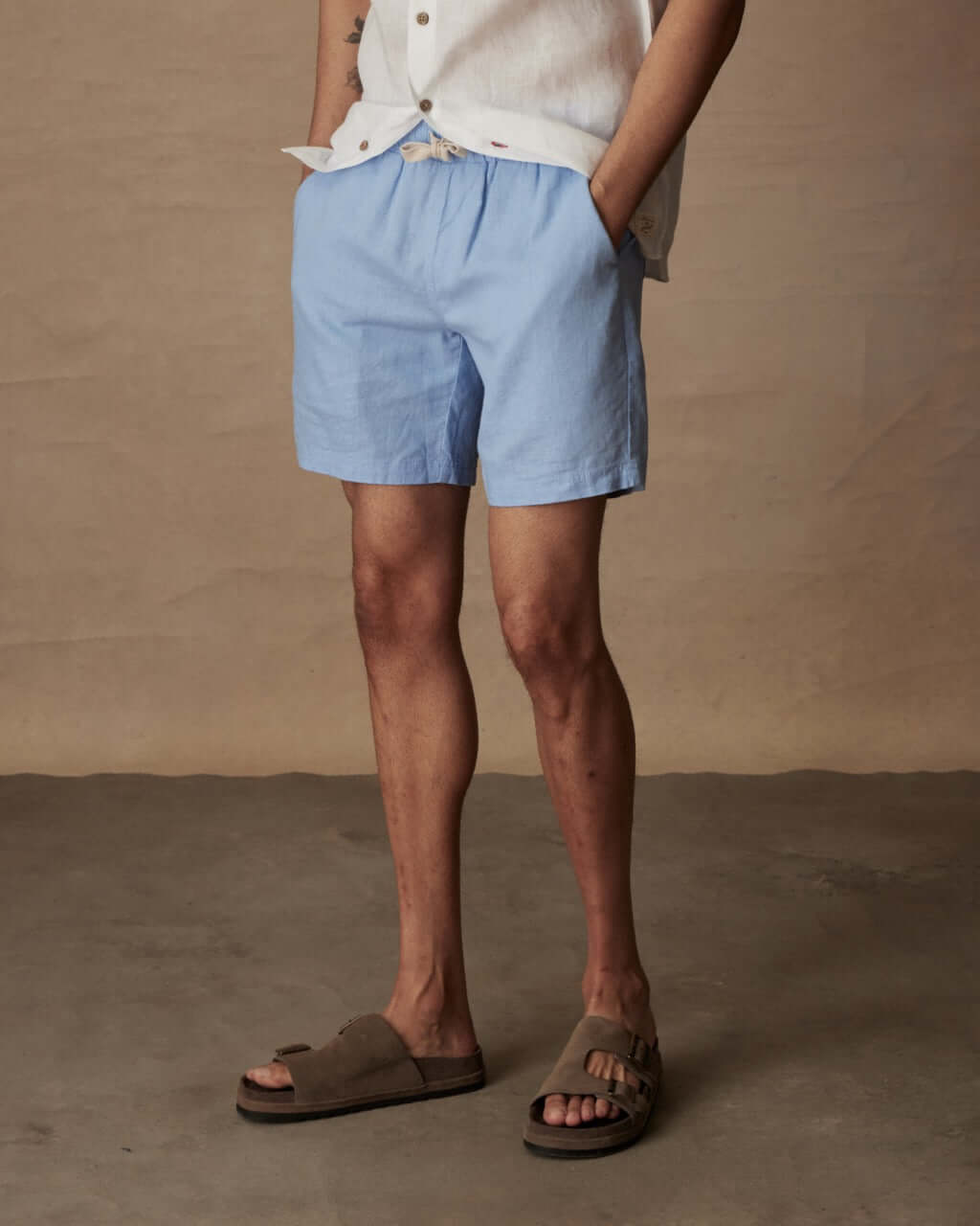 Men's 7" linen shorts in fjord blue with elastic waist and pockets, perfect for casual summer wear.