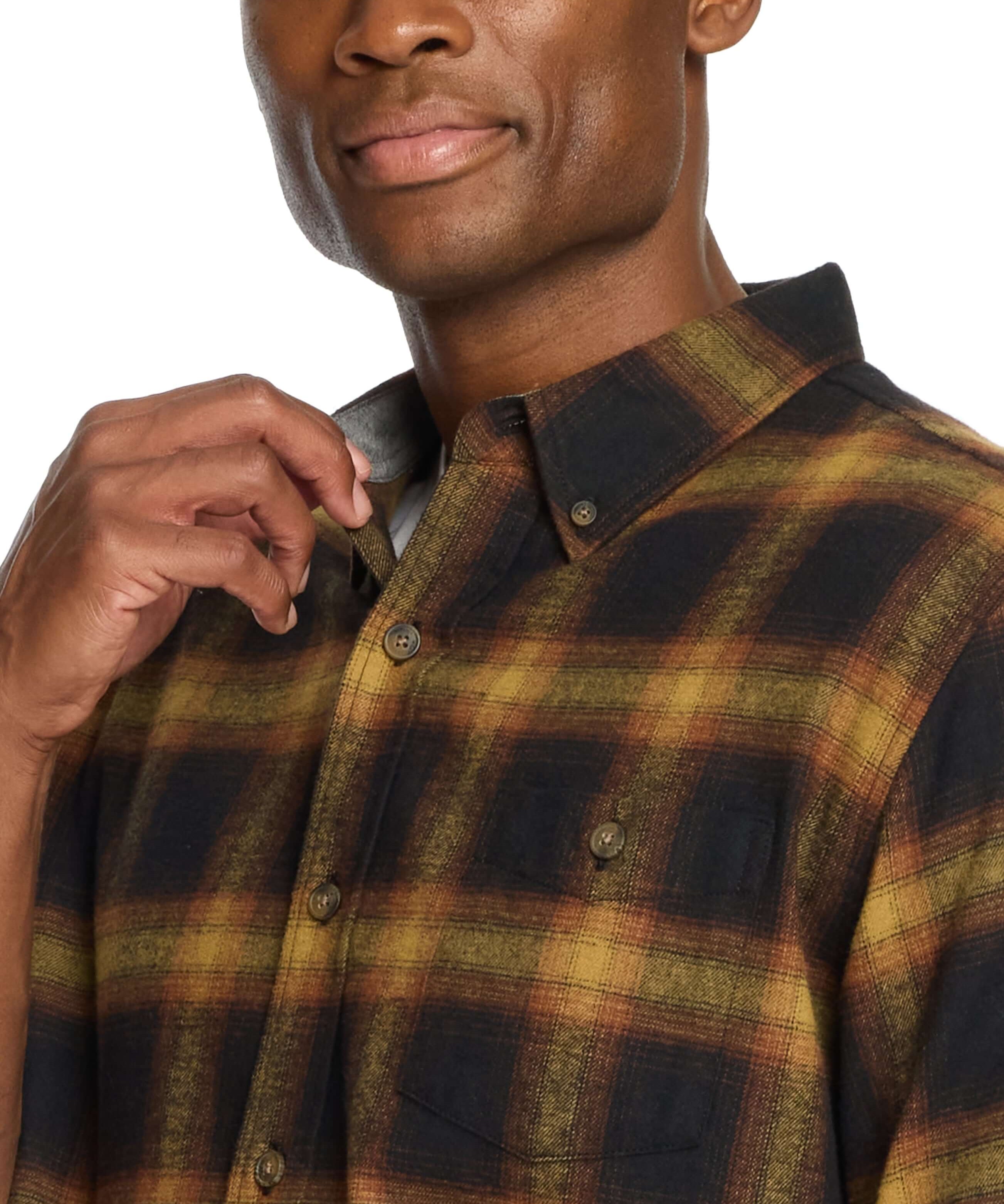 Close-up of a man wearing a long sleeve brushed flannel shirt in Inca Gold with plaid pattern and button-down collar.