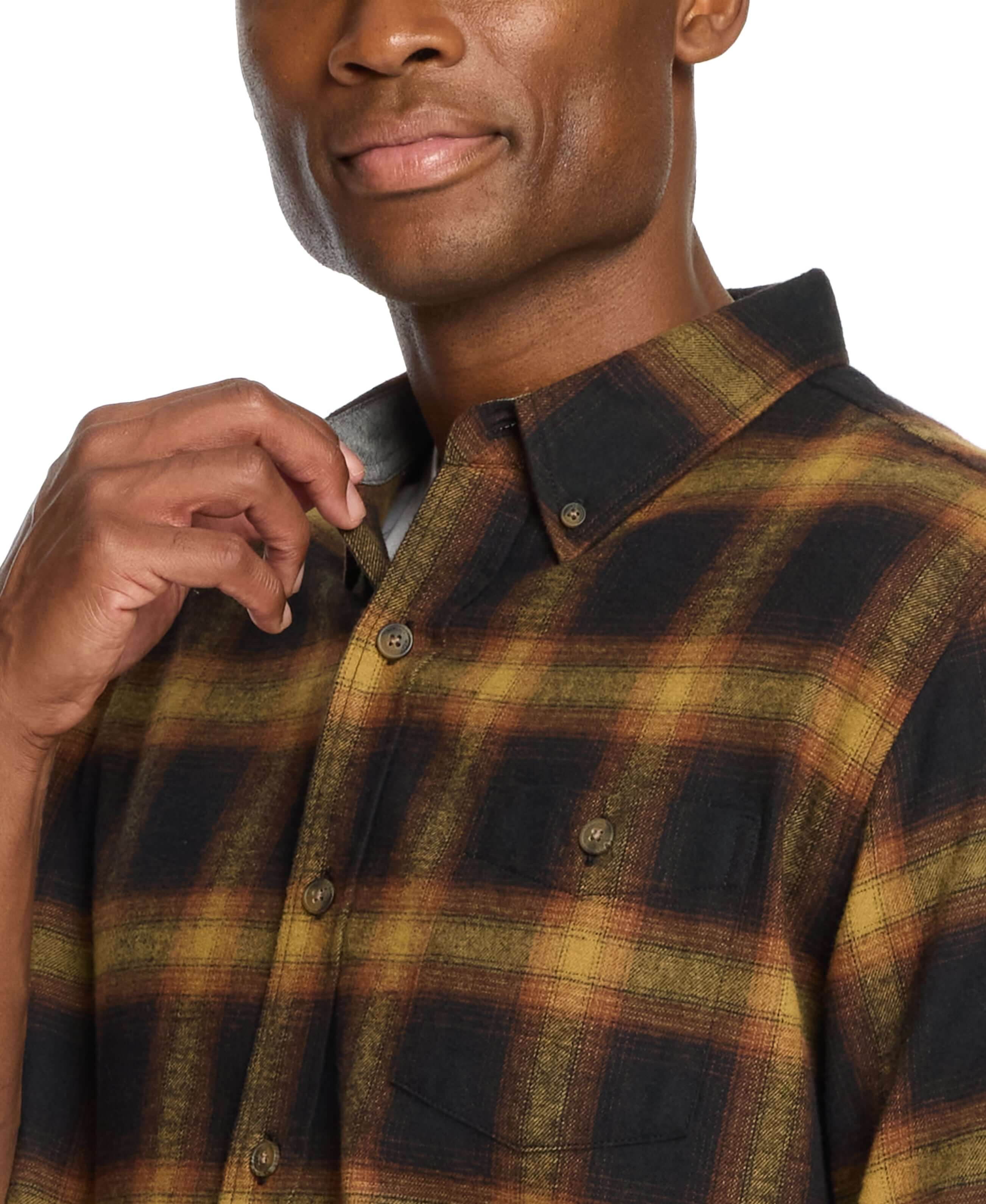 Close-up of a man wearing a long sleeve brushed flannel shirt in Inca Gold with plaid pattern and button-down collar.