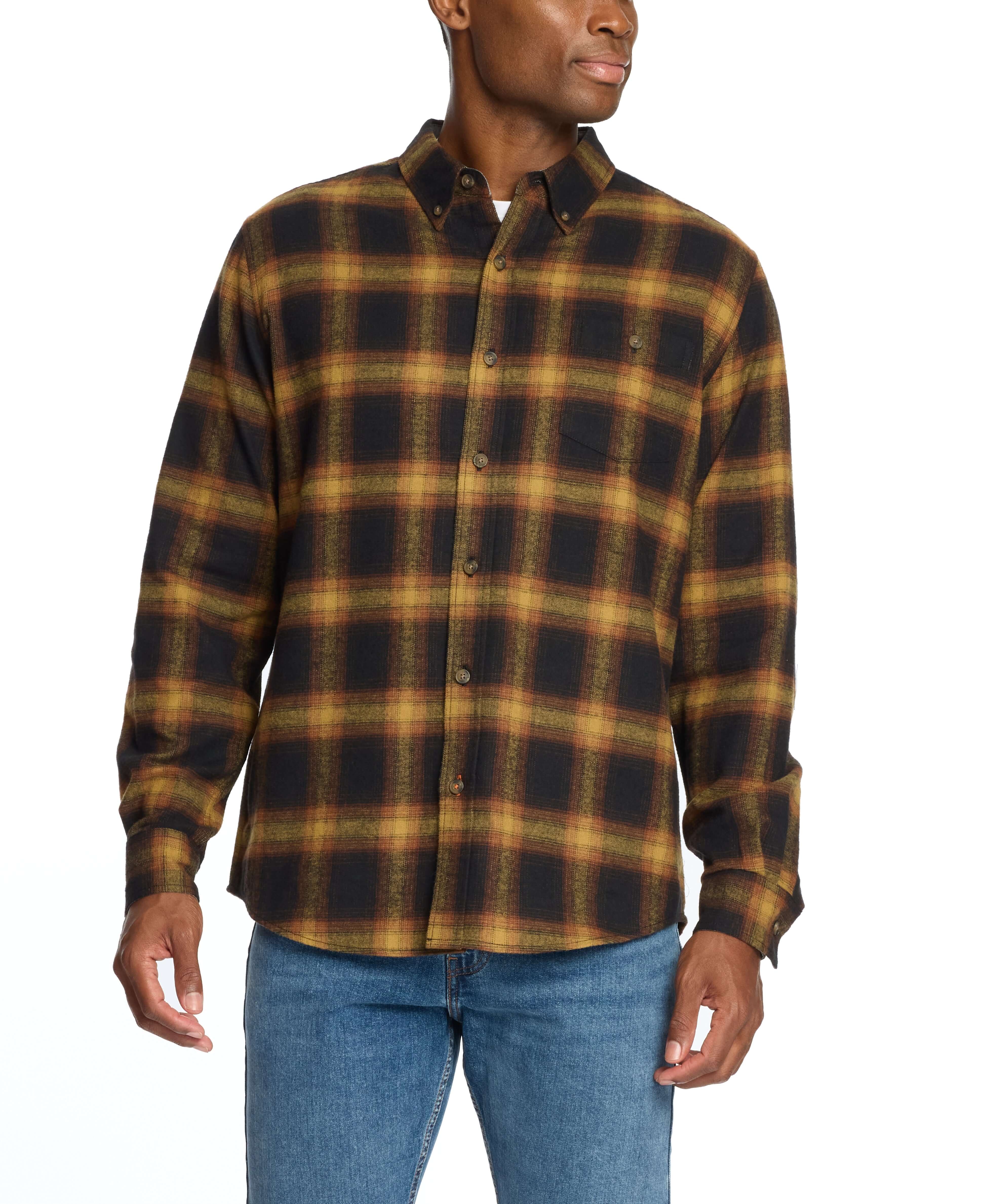 Man wearing a Long Sleeve Brushed Flannel in Inca Gold, featuring a classic plaid pattern and button-down collar.