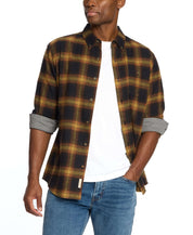 Man wearing a Long Sleeve Brushed Flannel in Inca Gold, showcasing a classic plaid pattern and casual style.